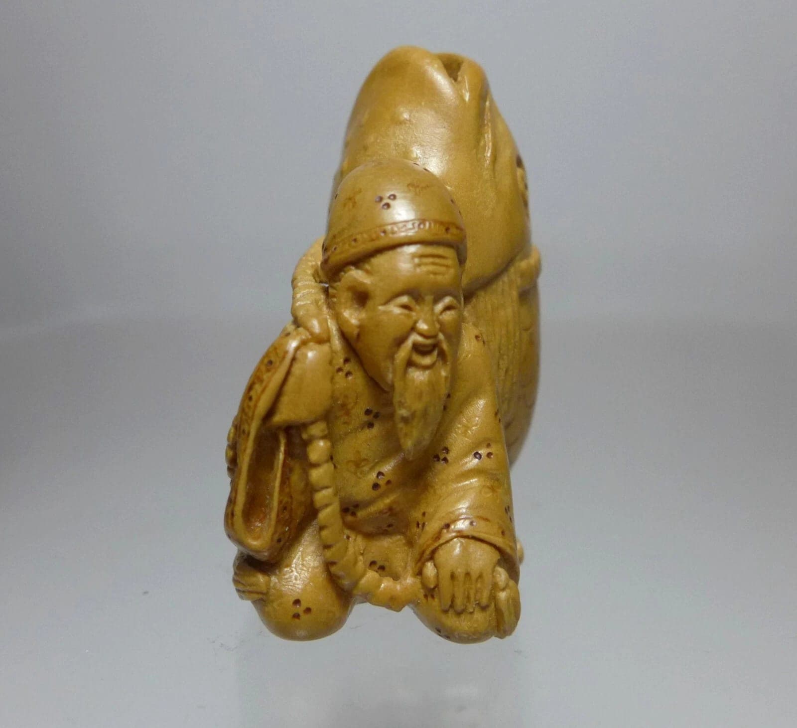 ALEXANDER DERKACHENKO, Contemporary Boxwood Netsuke, "Man Carrying Fish"